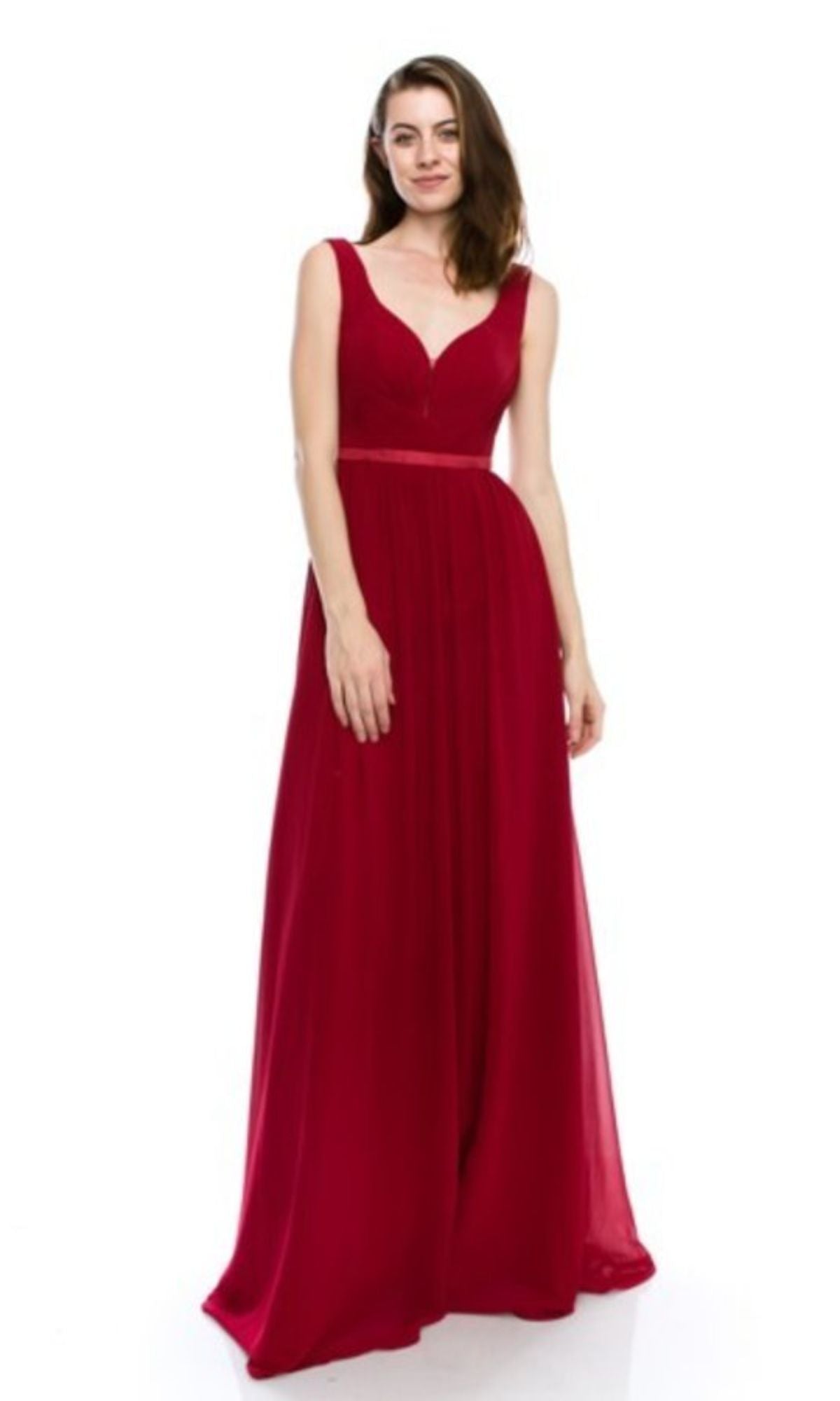 A woman models the Deep V-Back Long A-Line Prom Dress: Chicas C7818, a sleeveless, floor-length red gown with a fitted bodice and flowing skirt, standing against a plain white background.